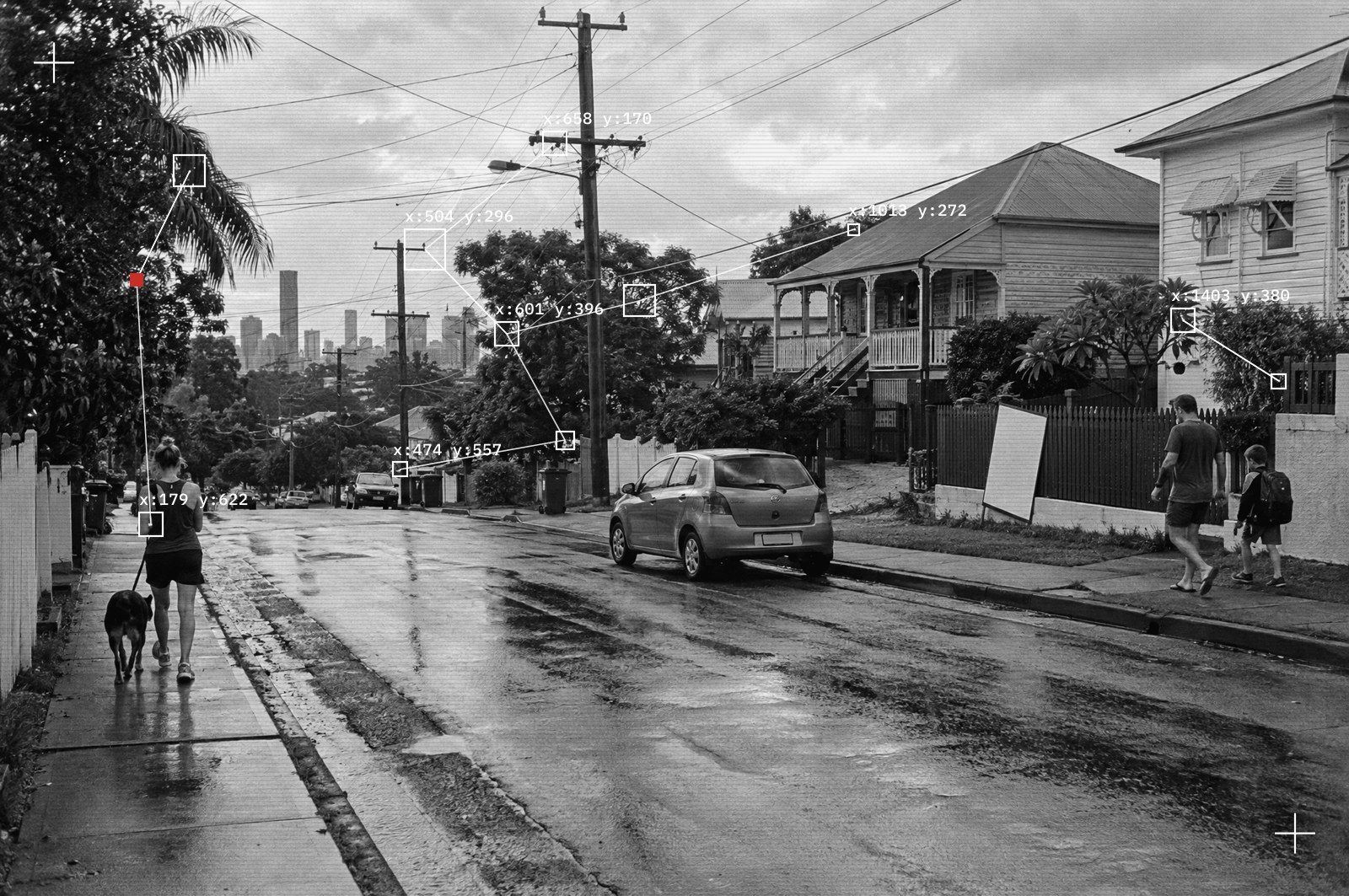 A Brisbane suburban street of Queenslanders after rain, the city skyline in the distance